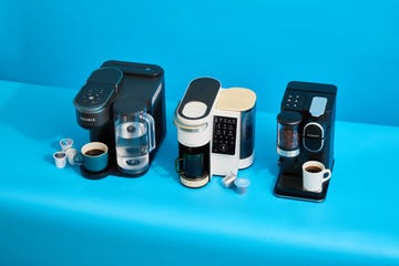 three single serve coffee makers on a blue background