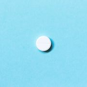 single white pills on a blue background medications flat lay concept medicine
