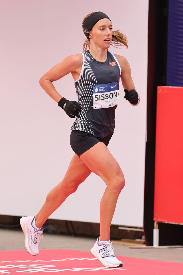 emily sisson wearing a new balance singlet while crossing the finish line at the 2023 chicago marathon