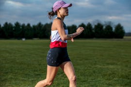 a runner wearing a hat and singlet