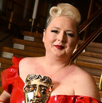 siobhan mcsweeney smiles as she holds her bafta trophy