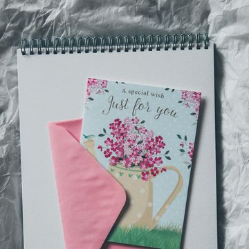a notebook with a picture of a flower and a pen on a table