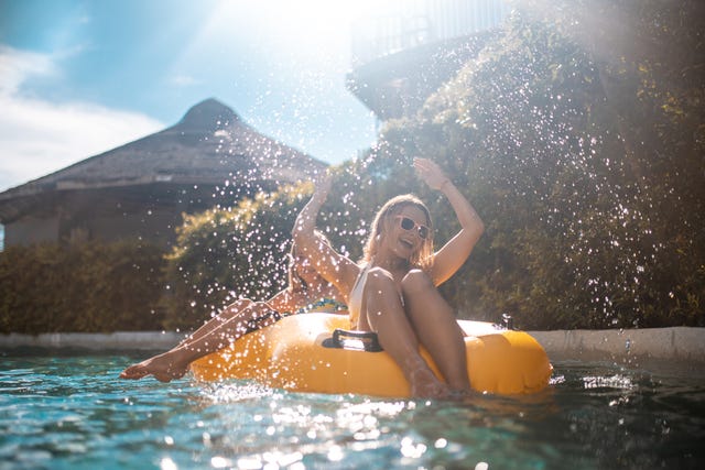 Sisters enjoying on inflatable ring at park