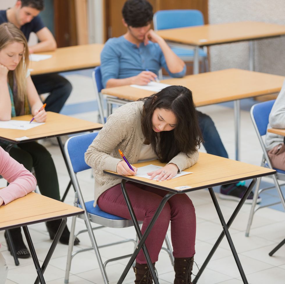 students writing in the exam hall of the college