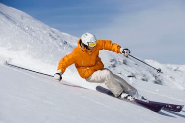 skier carving through powder snow