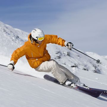 skier carving through powder snow