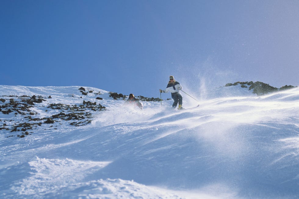 skier in powder down moguls, palisades tahoe squaw valley, california, usa