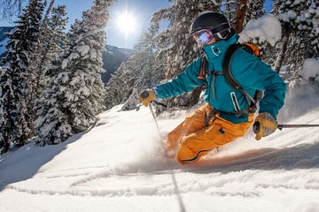 skier skiing powder on a sunny day