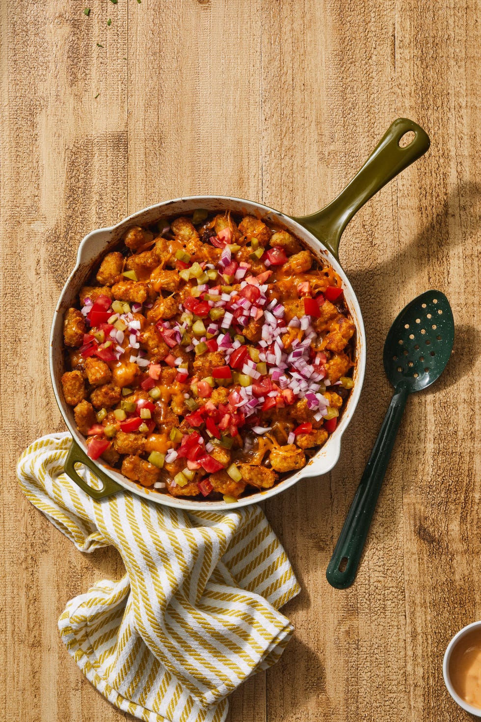 skillet cheeseburger hot dish with diced red onions on top
