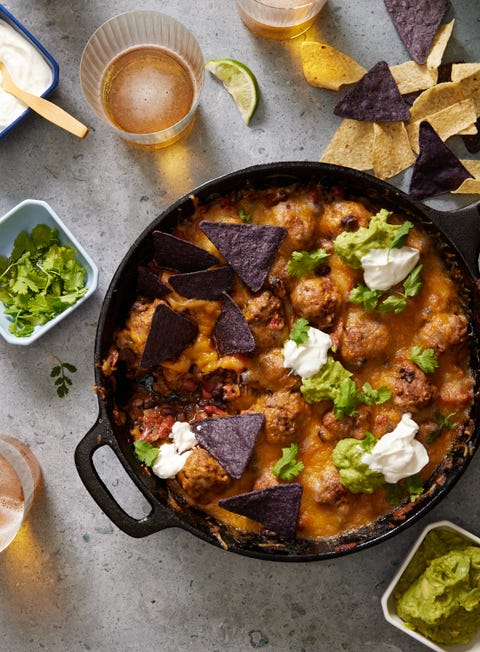 chili and meatballs in a cast iron skillet, topped with melty cheese