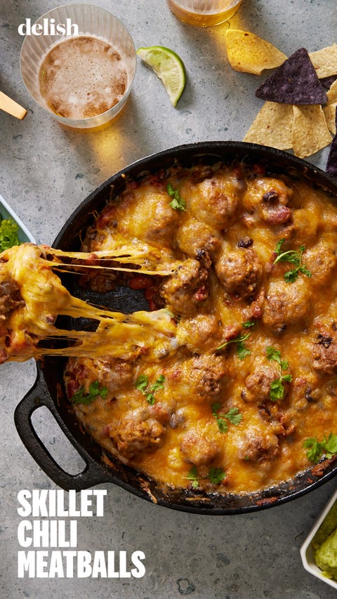 chili and meatballs in a cast iron skillet, topped with melty cheese