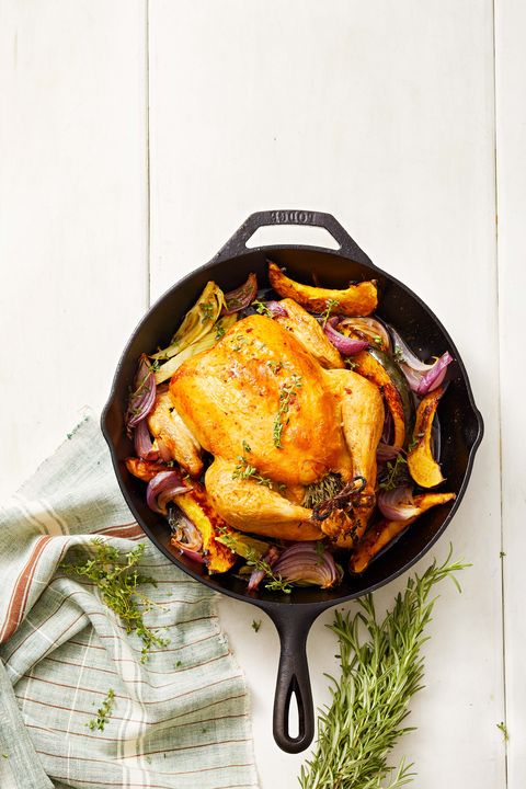 skillet roasted chicken with roasted onion in a cast iron