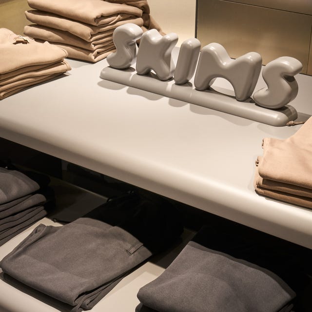 display of folded clothing with a brand logo