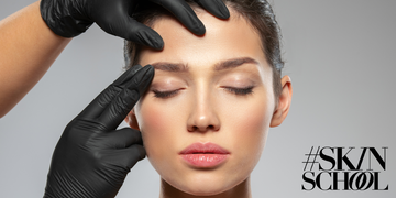 a close up image of a woman with her eyes closed and having her face examined