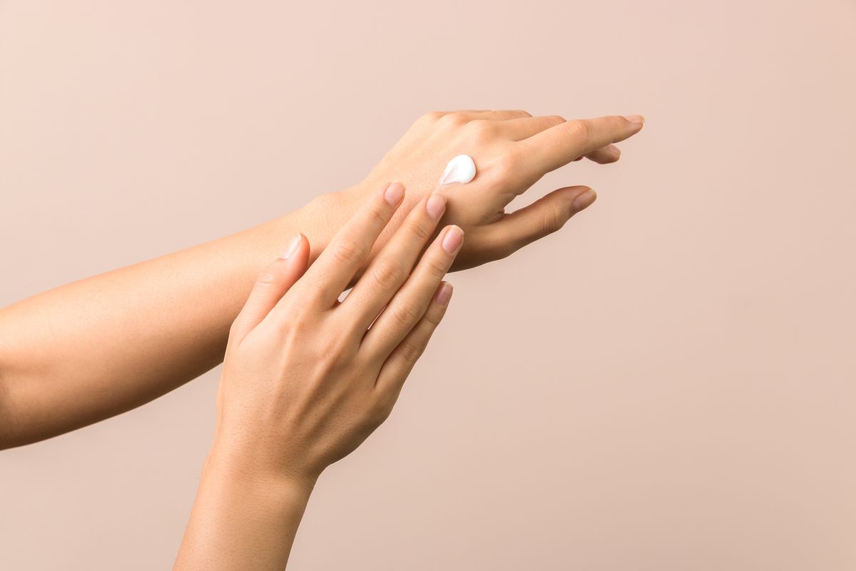 skincare close up view of woman hand moisturising them with cream skincare