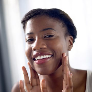 skincare, portrait and happy black woman with massage on face for wellness, beauty or glow in the morning health, clean and portrait of an african girl with a facial treatment or touching for care