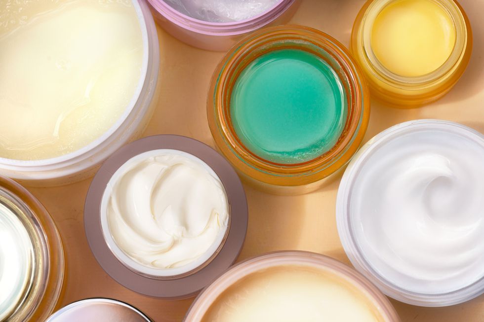 skincare scrubs, clay masks, salt treatments and softness creams on natural color background