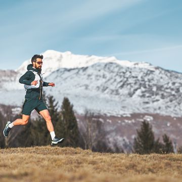 a skyrunner athlete man run in the high mountains