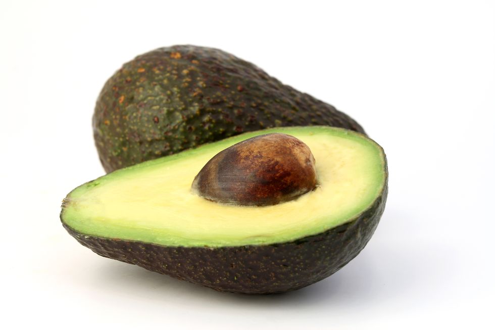 sliced avocado on white background