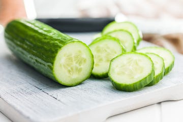 sliced fresh green cucumber on cutting board