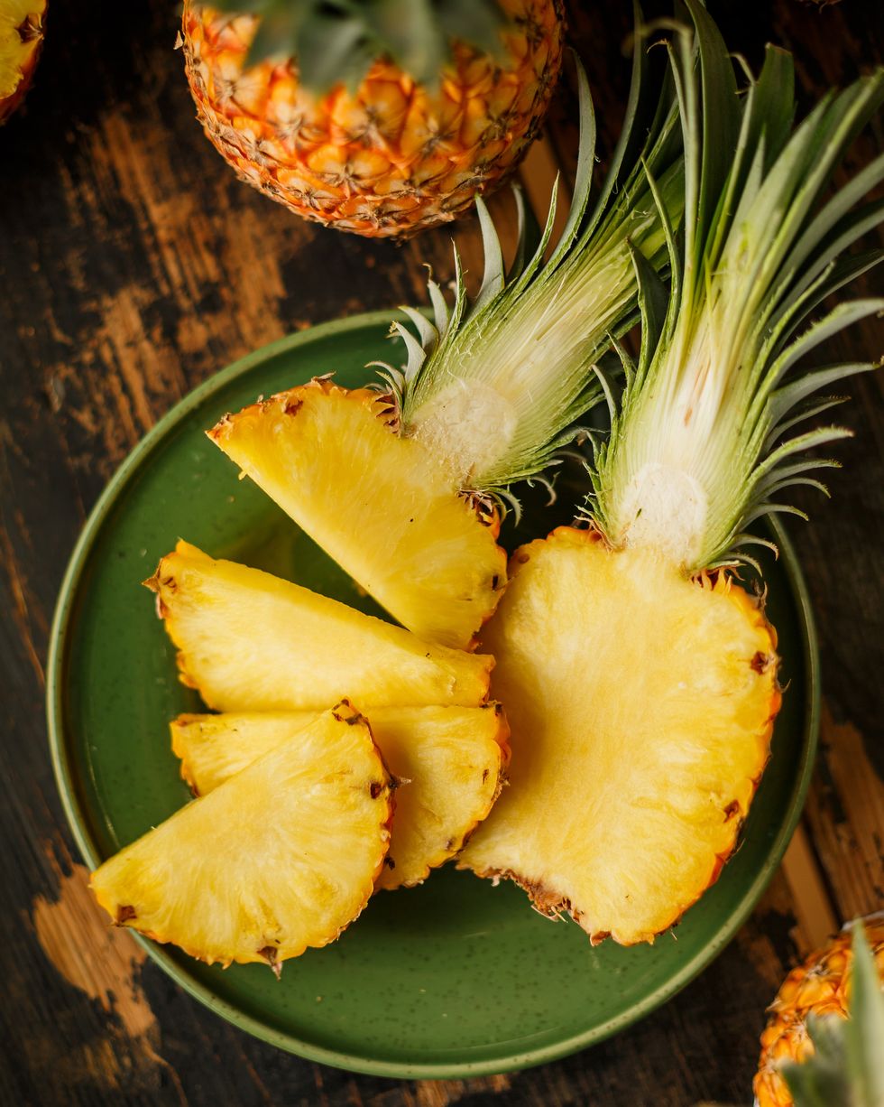 sliced pineapple on wooden background