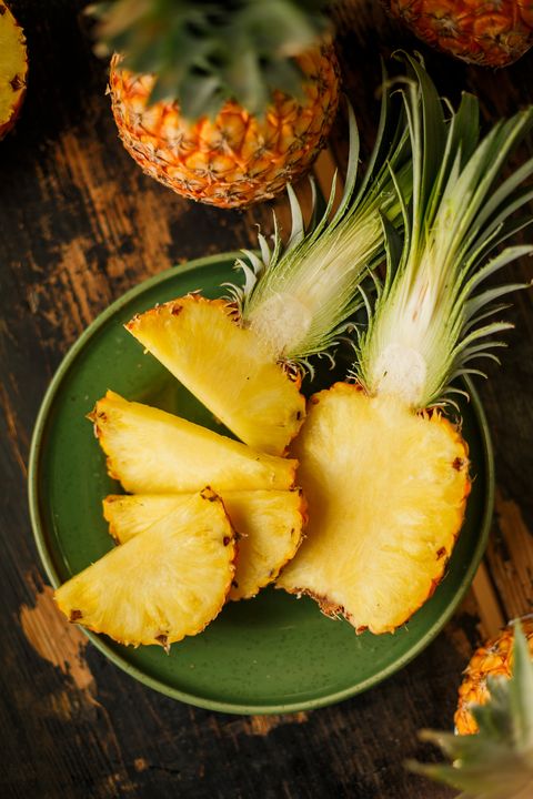sliced pineapple on wooden background