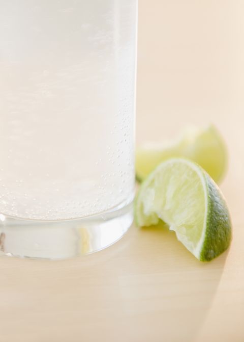 Slices of lime beside glass of water