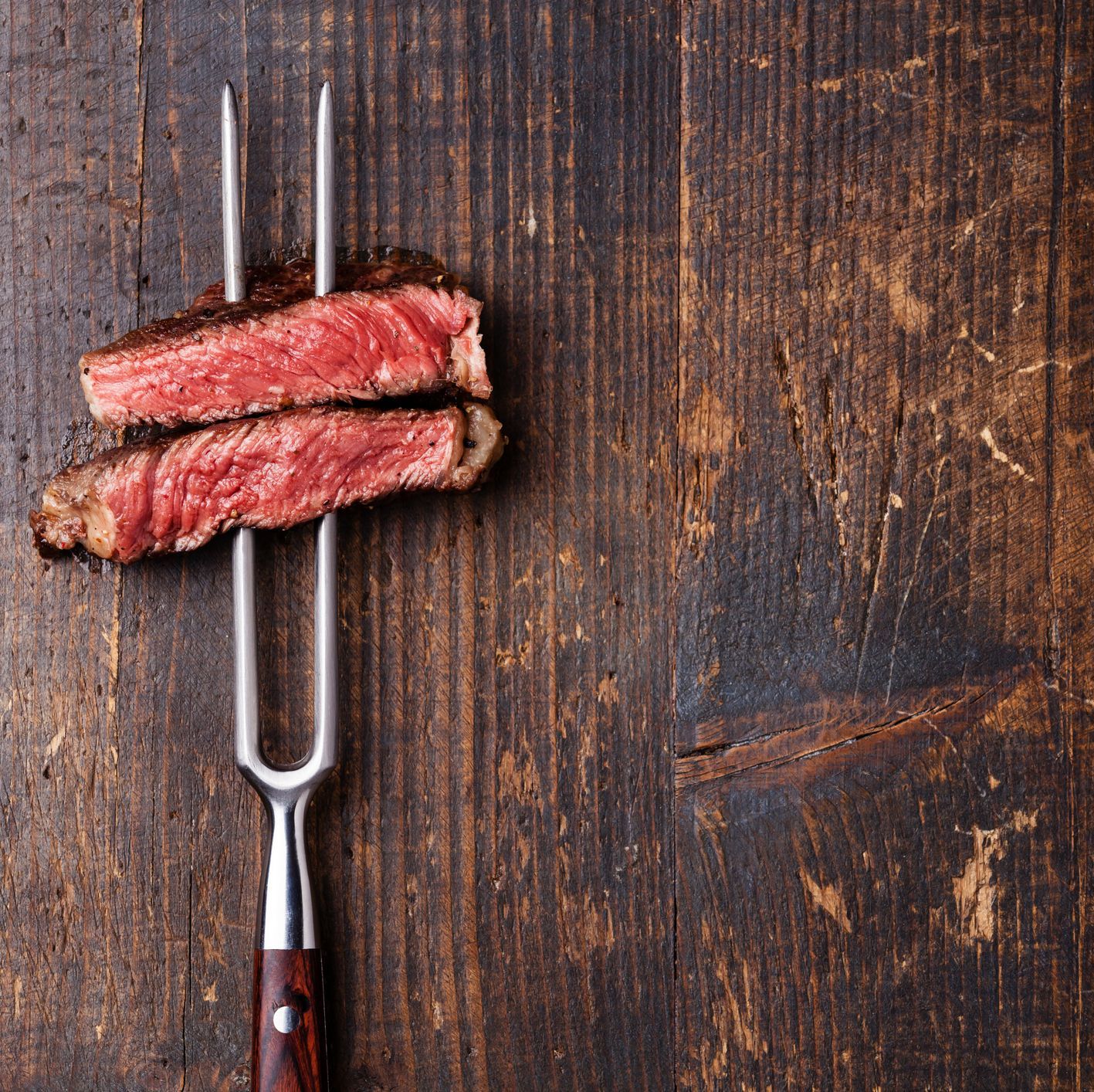 Slices of Steak Ribeye on meat fork