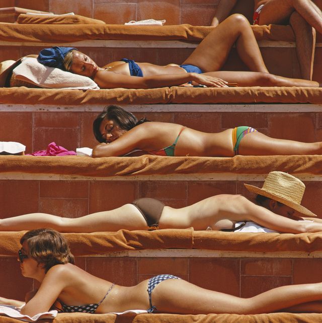 Young sexy girl sunbathing in the solarium in her underwear lying