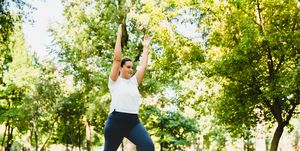 slimming burning calories exercises caucasian plump young woman athlete in fitness clothes doing yoga on fitness mat outdoors in park