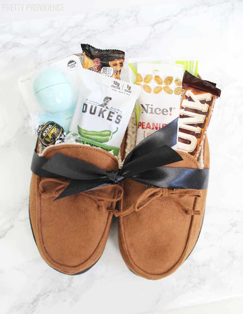 leather moccasin slippers tied with ribbon and filled with snacks
