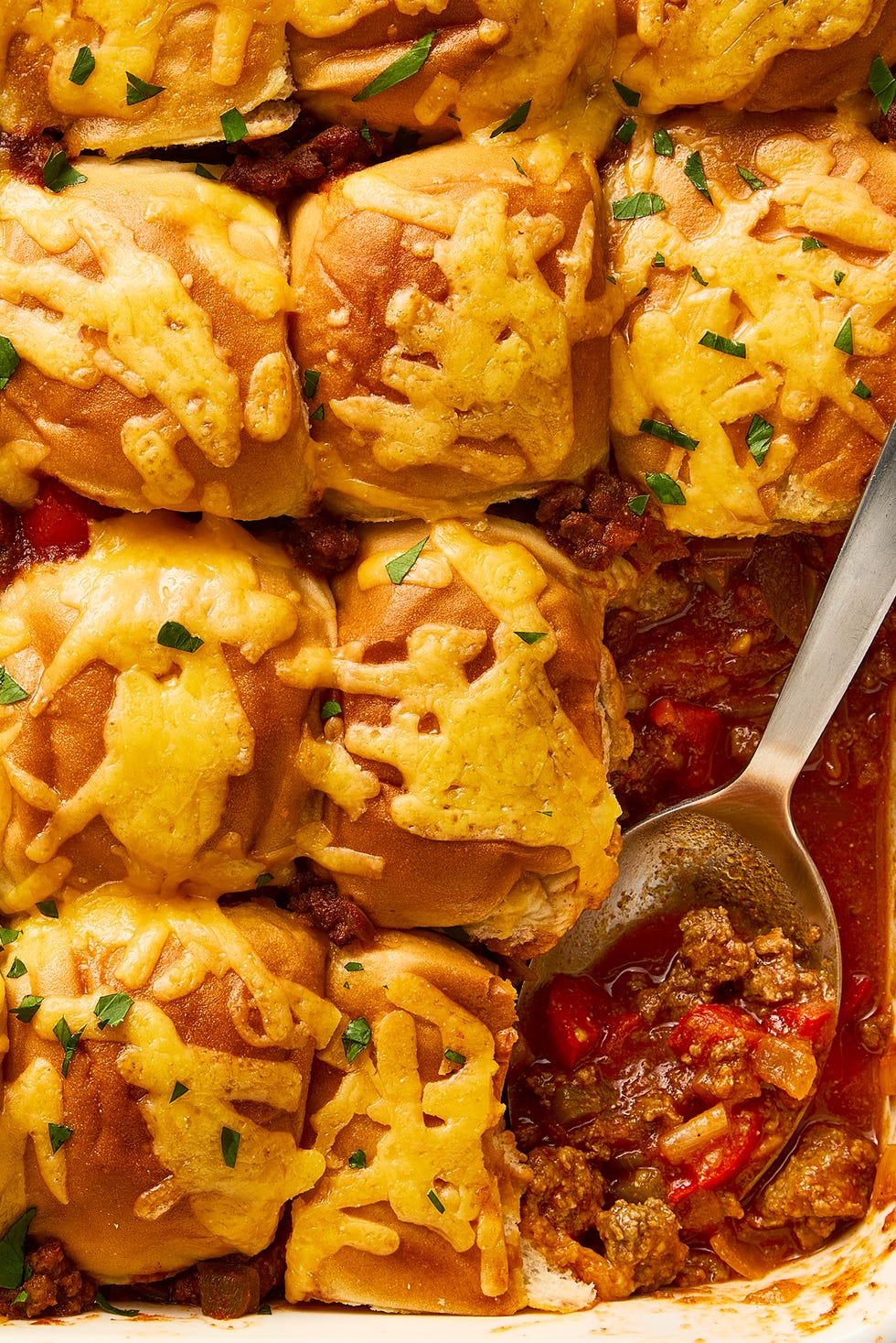 Sloppy Joe Casserole casserole dish with sloppy joe mixture topped with mini buns and melted cheese
