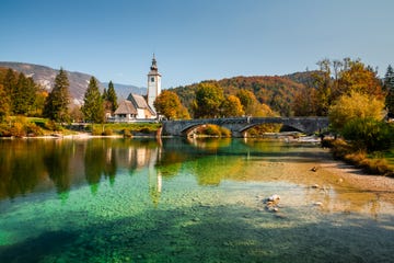 colorful bohinj lake, church of st john the baptist with bridge triglav national park, julian alps, slovenia,europe