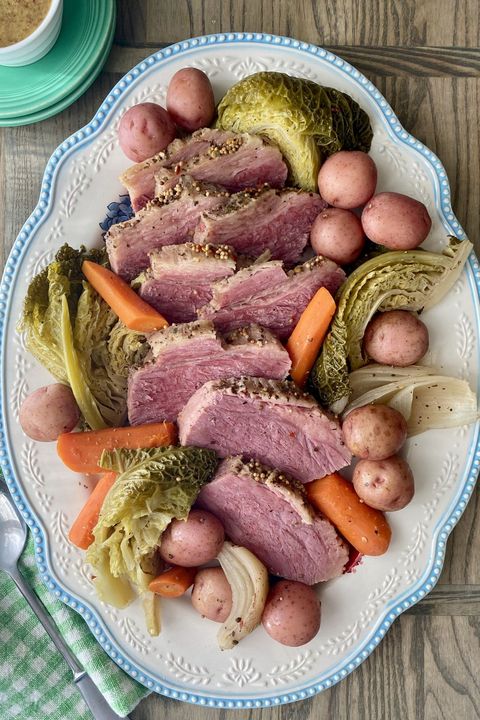slow cooker corned beef and cabbage on white and blue platter