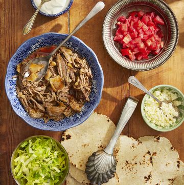 slow cooker beef taco ingredients in bowls on a cutting board