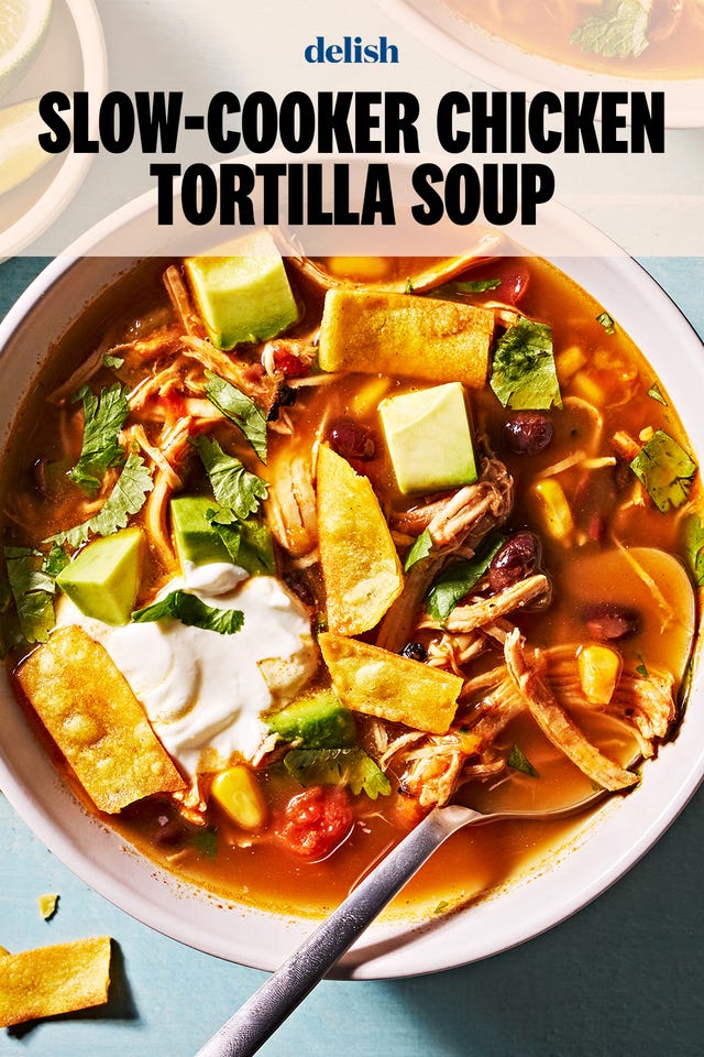 slow cooker chicken tortilla soup with sour cream, avocado slices, cheese and tortilla strips