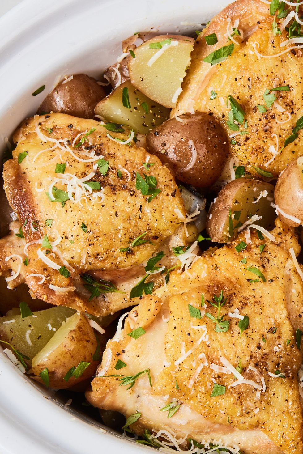slow cooker garlic parmesan chicken with fresh herbs and potatoes