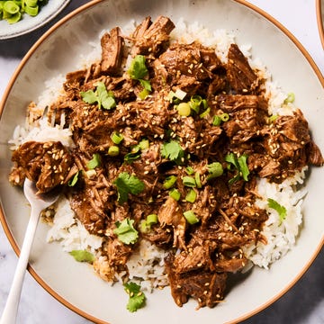 saucy korean style beef in a slow cooker with green onions