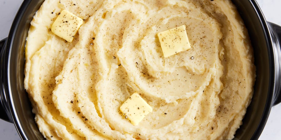 slow cooker mashed potatoes with a pat of butter, salt, and pepper