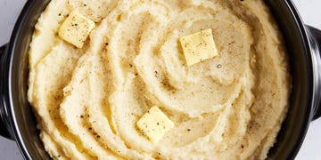 slow cooker mashed potatoes with a pat of butter, salt, and pepper