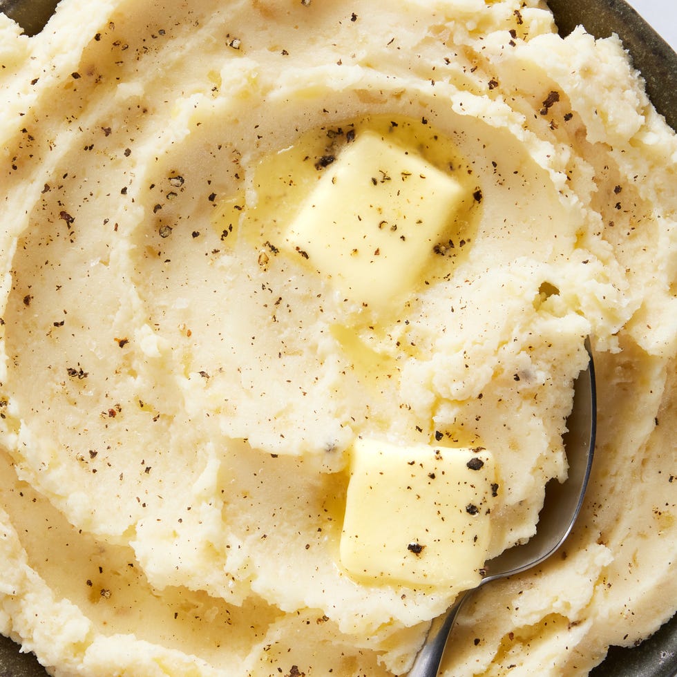 slow cooker mashed potatoes with a pat of butter, salt, and pepper