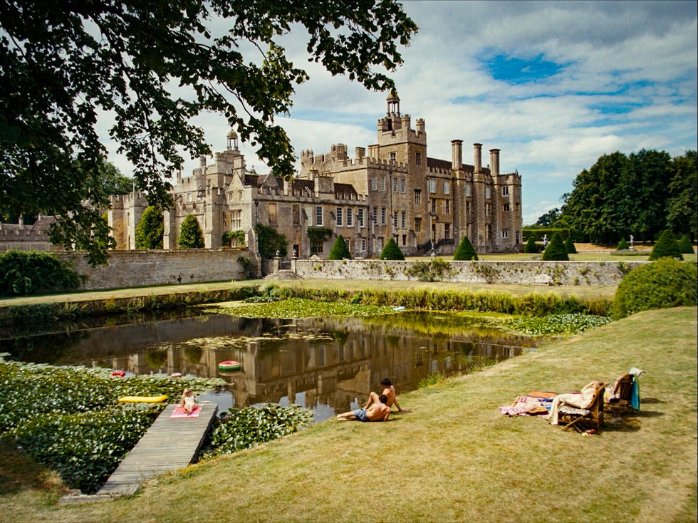 a large building with a pond in front of it