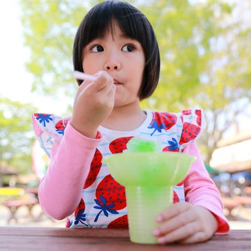 Little Girl Enjoy Melon Flavored Shaved Ice. Spring Season Activities little girl enjoy melon flavored shaved ice spring season activities