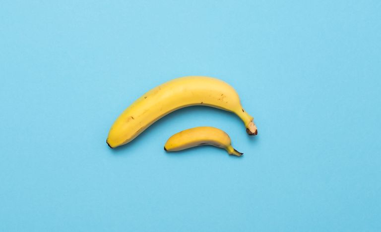 Small banana compare size with banana on blue background. size penis concept