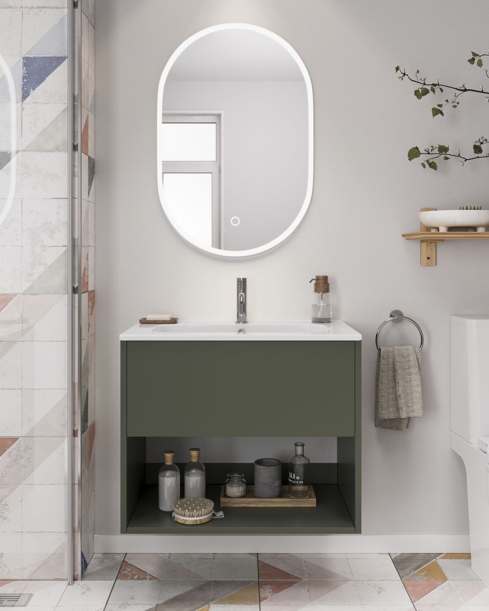 a small white bathroom with wall mounted green vanity unit and lit mirror