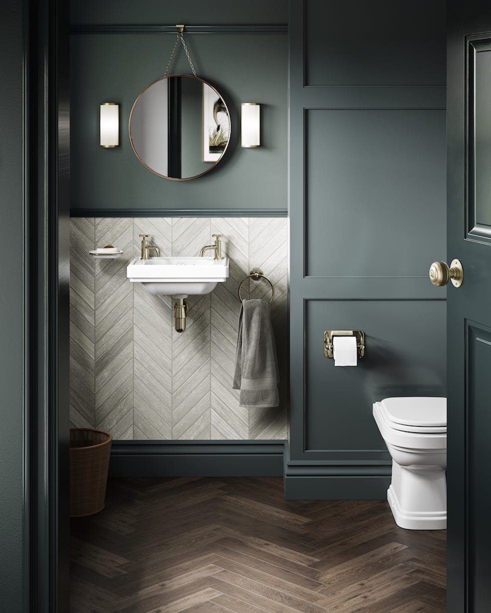 a small bathroom with dark grey painted panelling and a white burlington cloakroom sink
