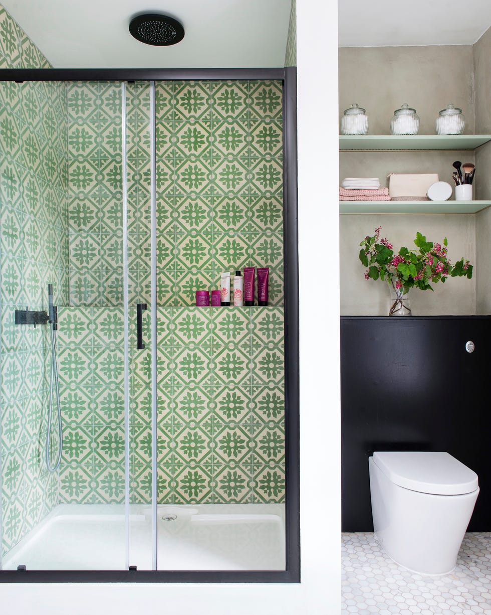 Small bathroom ideas - storage nook a small bathroom with green tiled shower and a recessed toilet with nook shelving above