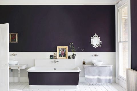 bathroom with dark painted walls and tub