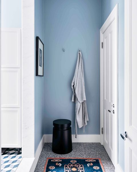 light blue bathroom with area rug