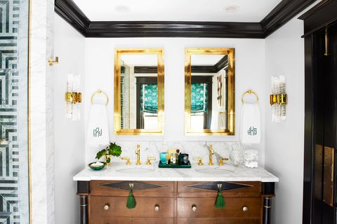 bathroom with gold mirrors and black high gloss trim